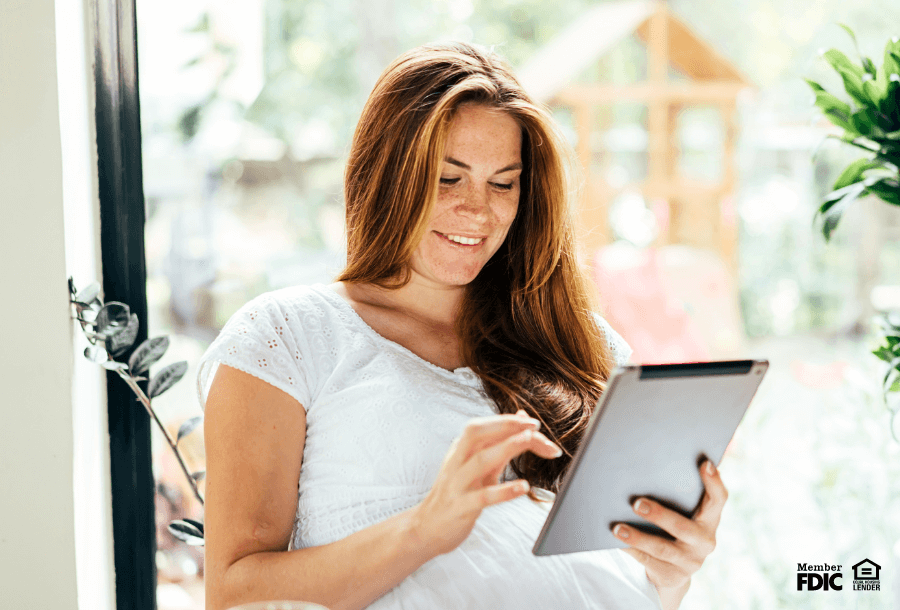 A woman checks on her emergency fund with online banking