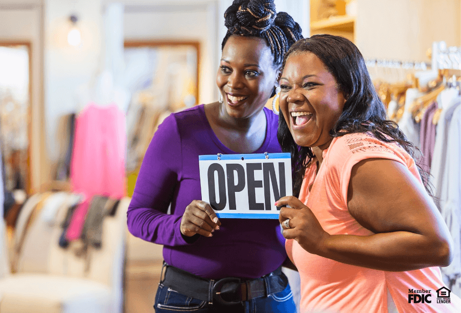 two business owners celebrate opening their store with an SBA loan.