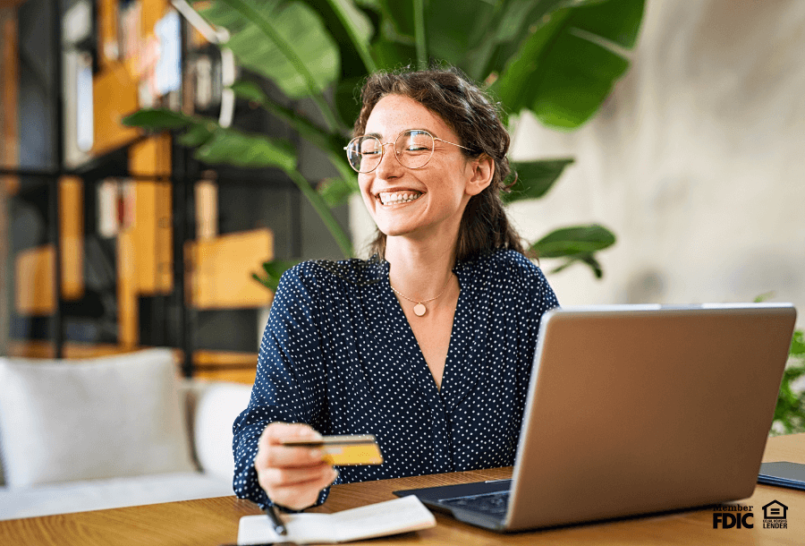 a woman celebrates the pros of having a secured credit card