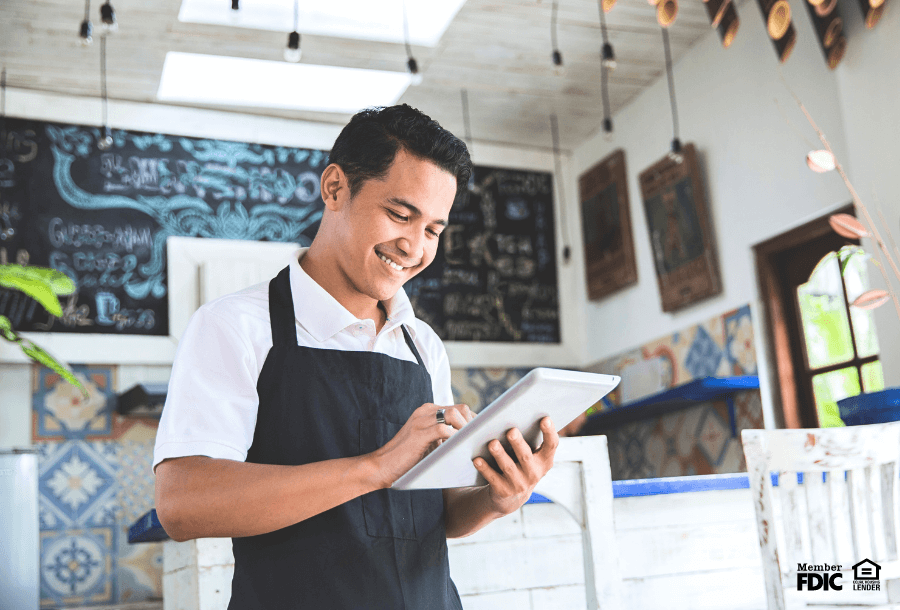 a business man checks his business checking account with online banking