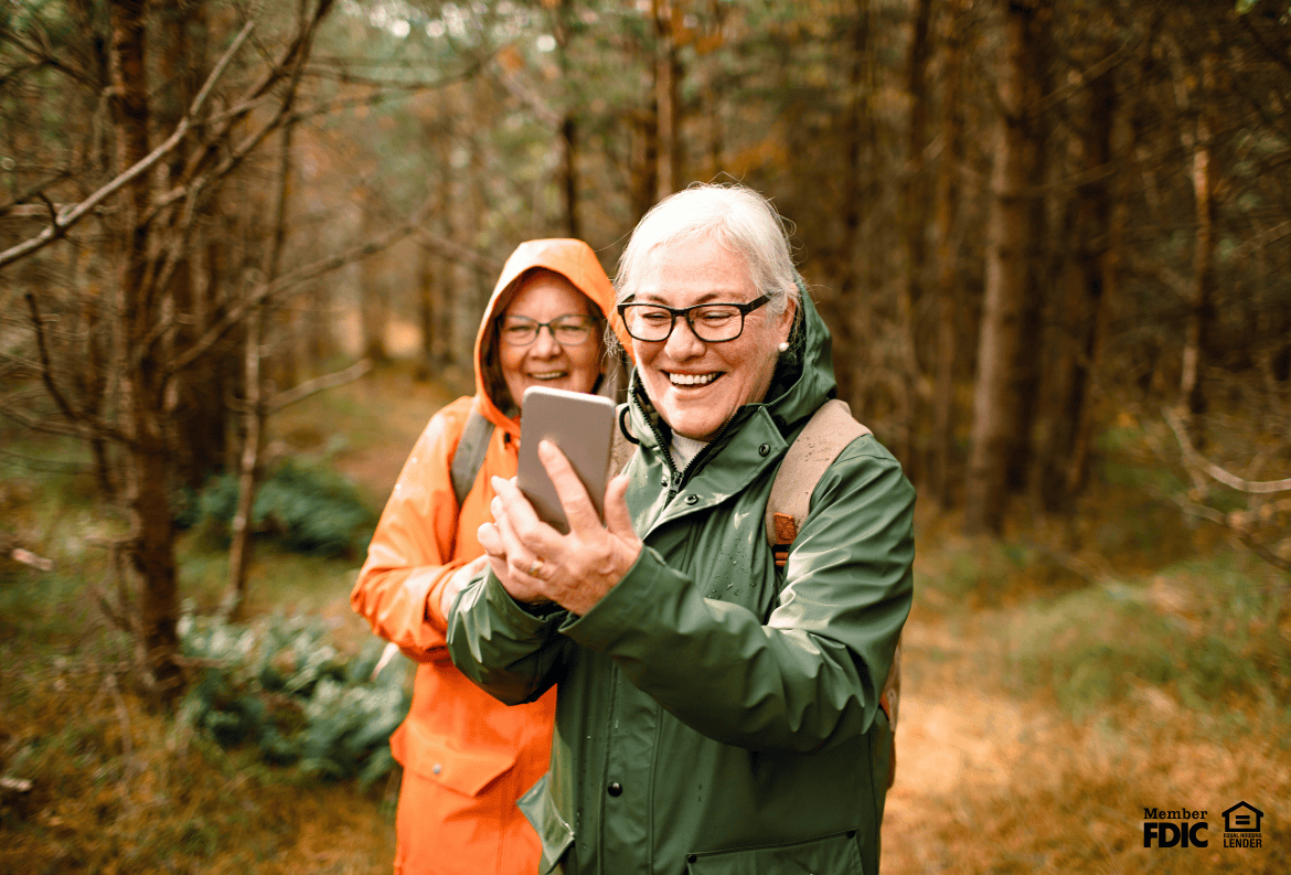 Woman enjoying easy access to her free checking account online while hiking.