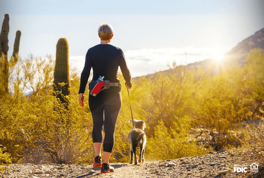 a woman walks her dog in Phoenix AZ