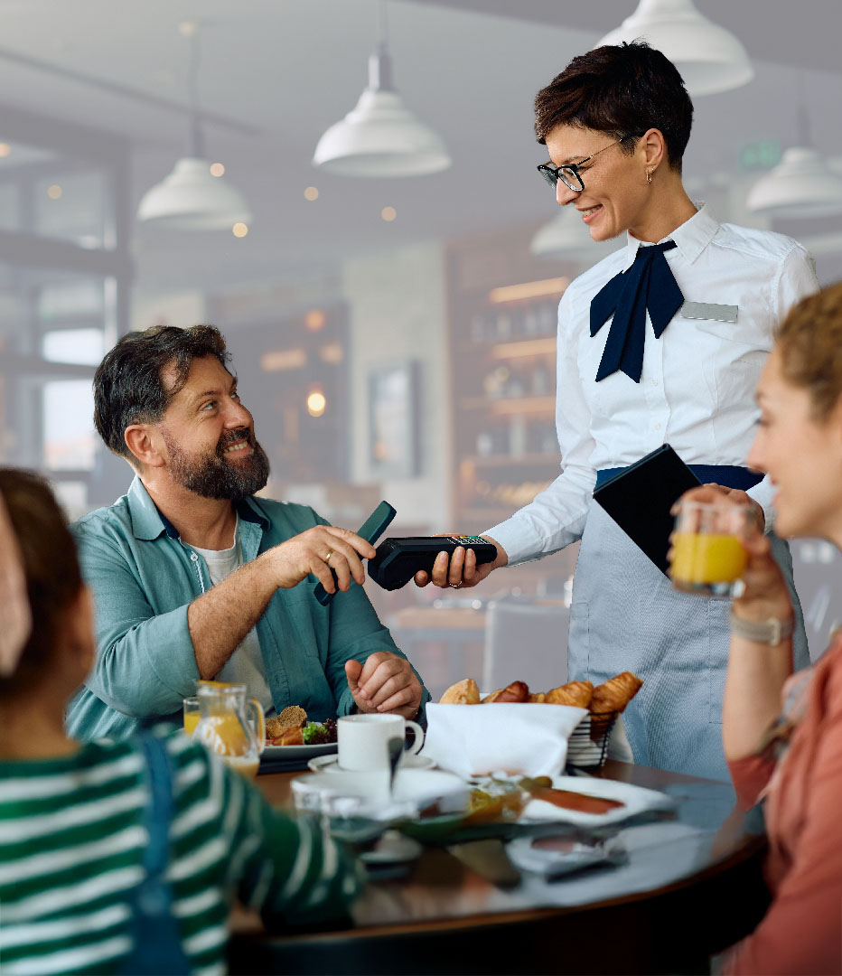 man paying for dinner with his digital wallet on phone