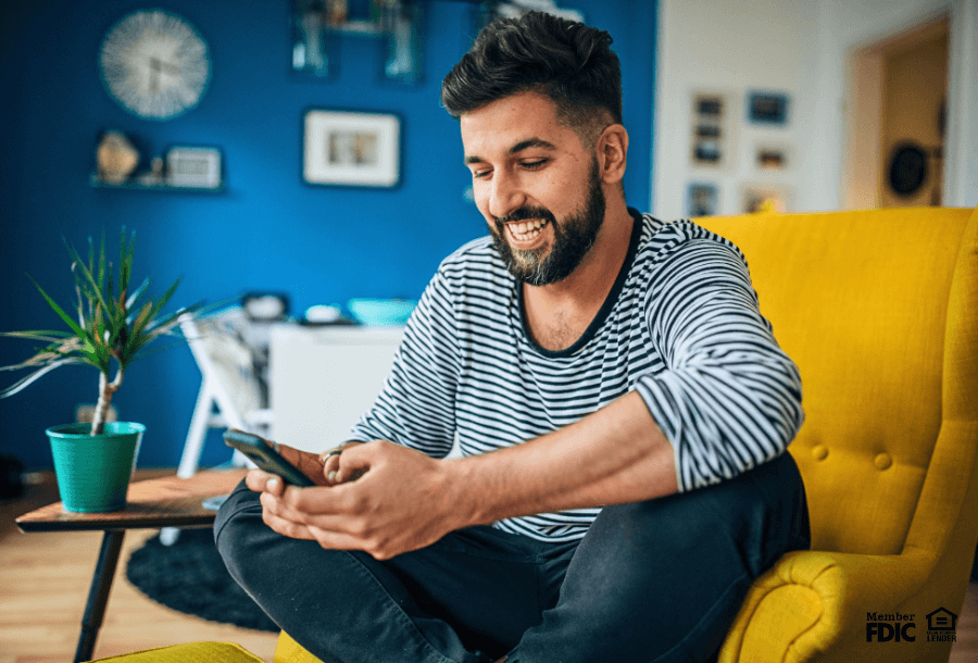 a man uses online banking to check his money market account.